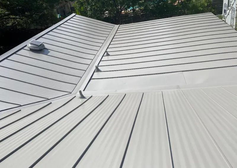 Solar attic fan installed on a metal roof for Roof Ventilation in Huntington Beach